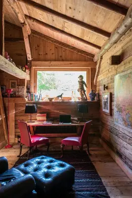 a living room with a desk and a window at Arthaus Megève in Demi-Quartier