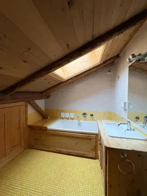 a large bathroom with a tub and a sink at Arthaus Megève in Demi-Quartier