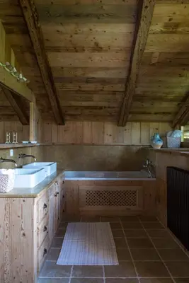 a large bathroom with a tub and a sink at Arthaus Megève in Demi-Quartier