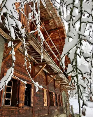 an old cabin in the snow with snow covered trees at Arthaus Megève in Demi-Quartier