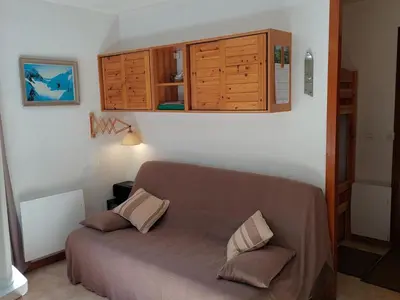 a bedroom with a bed and wooden cabinets at Appartement calme avec garage privatif près du centre à Chamonix - FR-1-517-61 in Chamonix-Mont-Blanc