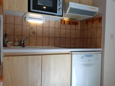 a small kitchen with a sink and a microwave at Appartement calme avec garage privatif près du centre à Chamonix - FR-1-517-61 in Chamonix-Mont-Blanc