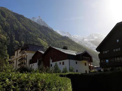 a group of buildings in front of a mountain at Appartement calme avec garage privatif près du centre à Chamonix - FR-1-517-61 in Chamonix-Mont-Blanc