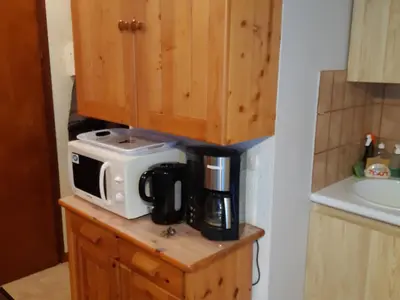 a microwave sitting on top of a counter in a kitchen at Appartement calme avec garage privatif près du centre à Chamonix - FR-1-517-61 in Chamonix-Mont-Blanc