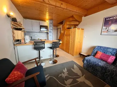 a room with a kitchen and a living room at Appartement charmant avec balcon et casier à ski à Samoëns - FR-1-624-89 in Samoëns