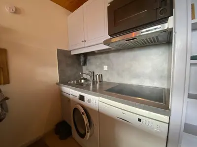 a kitchen with a sink and a washing machine at Appartement charmant avec balcon et casier à ski à Samoëns - FR-1-624-89 in Samoëns