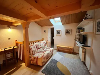 a living room with a couch and a kitchen at Appartement charmant avec balcon et casier à ski à Samoëns - FR-1-624-89 in Samoëns