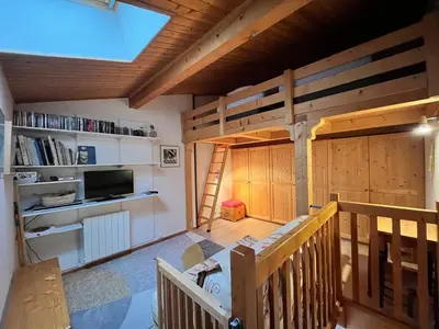 a room with a bunk bed and a ladder at Appartement charmant avec balcon et casier à ski à Samoëns - FR-1-624-89 in Samoëns