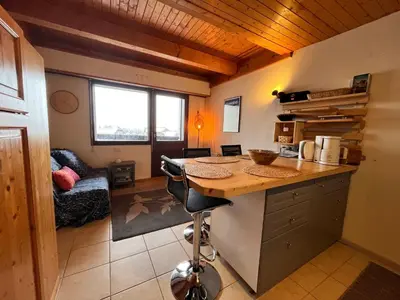 a kitchen with a counter and a desk in a room at Appartement charmant avec balcon et casier à ski à Samoëns - FR-1-624-89 in Samoëns