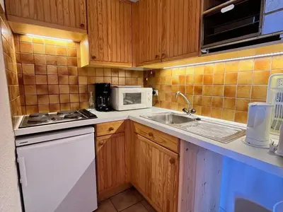 a kitchen with a sink and a microwave at Appartement cosy proche centre et skibus, parking inclus - FR-1-624-90 in Samoëns