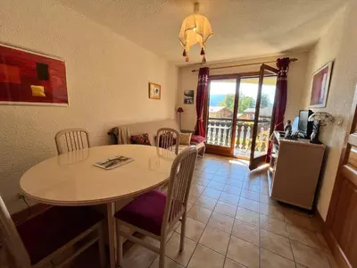 a kitchen with a table and chairs and a dining room at Appartement cosy proche centre et skibus, parking inclus - FR-1-624-90 in Samoëns
