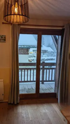 a large glass door with a view of a balcony at Studio sympa a saint Gervais les bains in Saint-Gervais-les-Bains