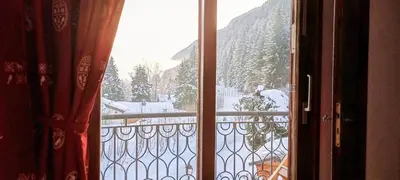 a view of a snow covered mountain from a window at Happy Moose - Cosy Mont Blanc View apartment with sauna in Chamonix-Mont-Blanc