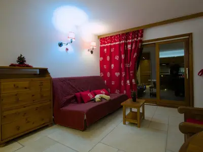 a living room with a couch with a dog sleeping on it at Happy Moose - Cosy Mont Blanc View apartment with sauna in Chamonix-Mont-Blanc