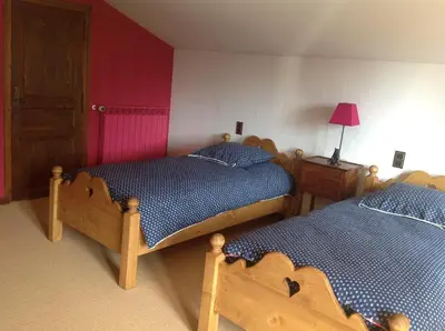 a white sink in a bathroom with a wooden door at Les Grangettes 2 - DUPLEX - WIFI gratuite in Les Carroz d'Araches