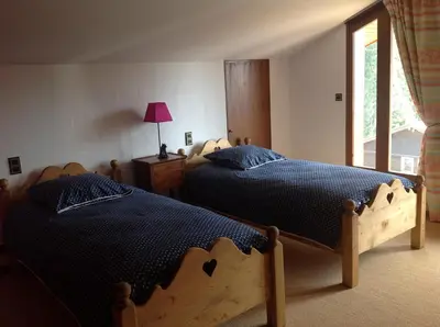 a yard with a playground with a swing at Les Grangettes 2 - DUPLEX - WIFI gratuite in Les Carroz d'Araches