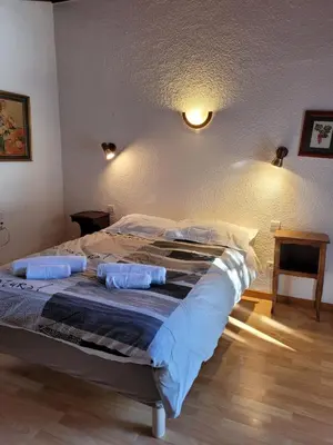 a bed in a bedroom with two pillows on it at Chalet LE TRIOLET in Chamonix-Mont-Blanc