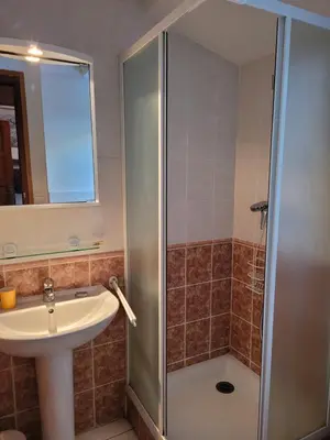 a bathroom with a shower and a sink at Chalet LE TRIOLET in Chamonix-Mont-Blanc