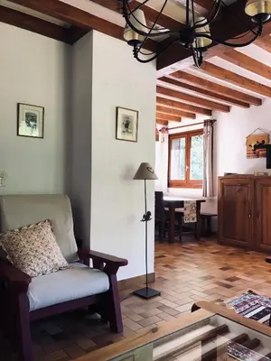 a living room with a couch and a table at Chalet Rivière du Bon Nant Location de 6 à 14 personnes en Haute Savoie in Saint-Gervais-les-Bains