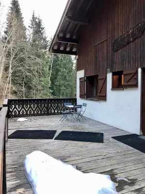 a wooden deck with benches on top of a building at Chalet Rivière du Bon Nant Location de 6 à 14 personnes en Haute Savoie in Saint-Gervais-les-Bains
