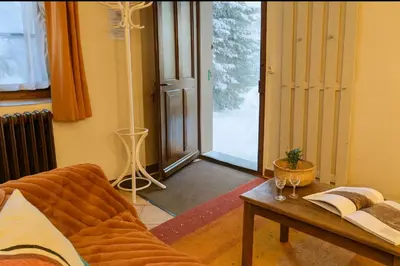 a living room with a couch and a table at Family House With Balcony Garden Wi Fi in Chamonix-Mont-Blanc