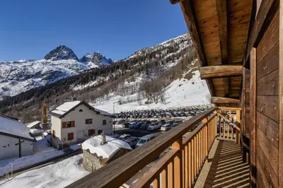 a balcony with a view of the snow covered mountains at La Ferme à Roland ski in - ski out - Happy Rentals in Chamonix-Mont-Blanc