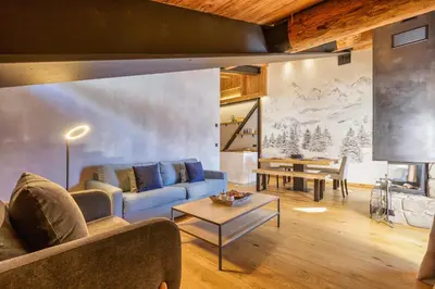 a living room with a couch and a table at La Ferme à Roland ski in - ski out - Happy Rentals in Chamonix-Mont-Blanc
