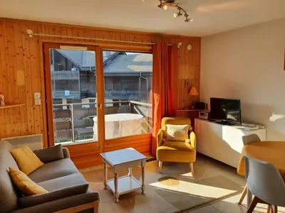a living room with a bed and a table at Appartement confort 4 pers avec balcon et garage, coeur de Samoëns - FR-1-629-101 in Samoëns