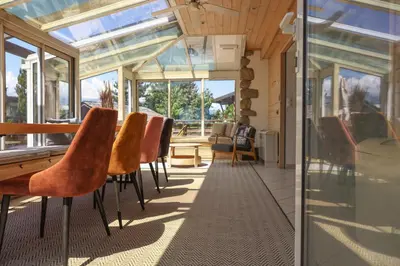 a conservatory with a row of chairs in a house at Chalet Belle-Sofianna in Saint-Gervais-les-Bains