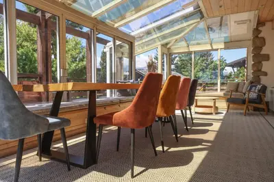 a room with a table and chairs and windows at Chalet Belle-Sofianna in Saint-Gervais-les-Bains