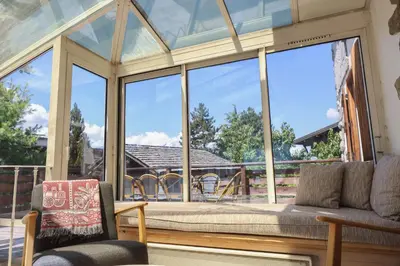 a screened in porch with a large glass window at Chalet Belle-Sofianna in Saint-Gervais-les-Bains