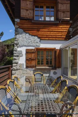 a group of chairs and a table on a patio at Chalet Belle-Sofianna in Saint-Gervais-les-Bains
