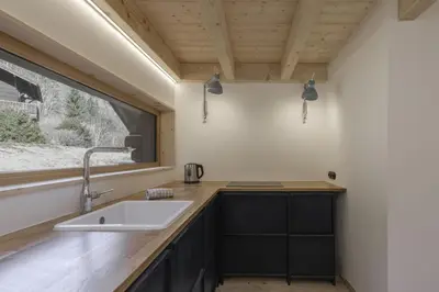 a kitchen with a sink and a window at Chalet L'Oratoire & Mazot - Renovated Historic Chalet - Huge Garden & Separate Cabin for 2 in Les Houches