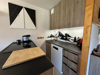 a balcony with chairs and a table and some buildings at Appartement 6 personnes avec balcon proche jardin d'enfants - FR-1-642-62 in Morillon