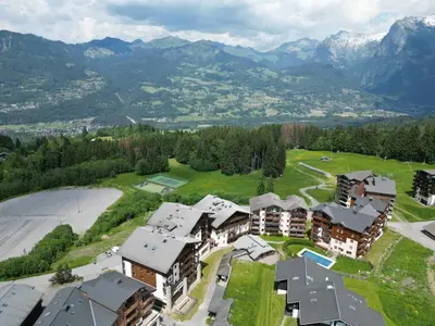 a tall building on the side of a road at Appartement 6 personnes avec balcon proche jardin d'enfants - FR-1-642-62 in Morillon