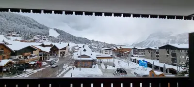 a town with snow covered buildings and a mountain at Vintage chic -central, wifi, mountain view-BelleVue3 in Les Carroz d'Araches