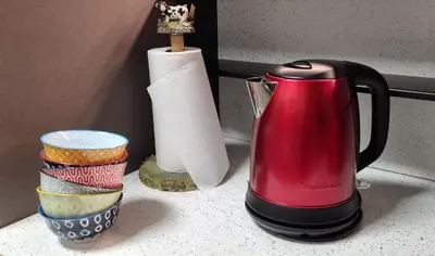 a red coffee maker on a counter with a roll of paper towels at Vintage chic -central, wifi, mountain view-BelleVue3 in Les Carroz d'Araches
