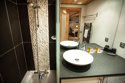 a bathroom with two sinks and a shower at Apartment Blaitiere - luxurious 2 bed apartment in Chamonix-Mont-Blanc