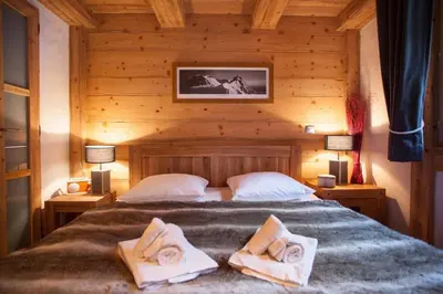 a bedroom with a bed with two towels on it at Apartment Blaitiere - luxurious 2 bed apartment in Chamonix-Mont-Blanc
