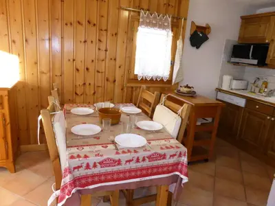 a kitchen with a table with a table cloth on it at Résidence Les Carlines - Carlines 3 MAE-8424 in Les Contamines-Montjoie