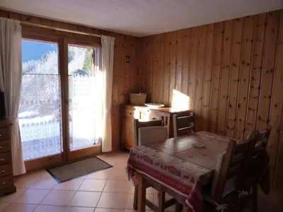 a room with a table and a desk and a window at Résidence Les Carlines - Carlines 3 MAE-8424 in Les Contamines-Montjoie