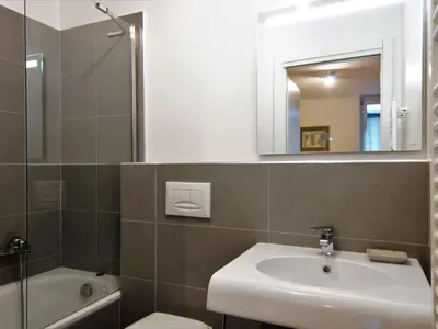 a bathroom with a sink and a toilet and a mirror at Apartment Le Paccard-2 by Interhome in Chamonix-Mont-Blanc