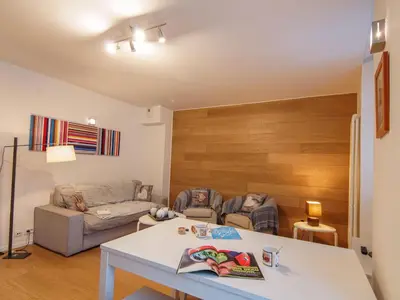 a living room with a table and a couch at Apartment Le Paccard-2 by Interhome in Chamonix-Mont-Blanc
