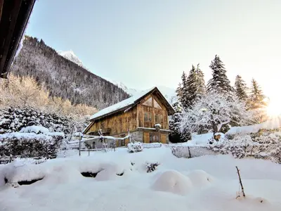 a living room with a couch and a table at Apartment Maison Maffioli by Interhome in Chamonix-Mont-Blanc