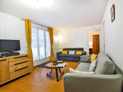 a living room with a couch and a table at Apartment Maison Maffioli by Interhome in Chamonix-Mont-Blanc