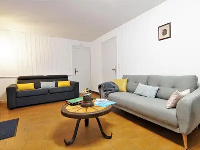 a living room with a table and a couch at Apartment Maison Maffioli by Interhome in Chamonix-Mont-Blanc