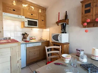 a living room with a couch and a kitchen at Apartment Bel Alp 23 by Interhome in Saint-Gervais-les-Bains