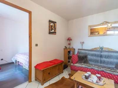 a bedroom with a bed and a door leading to a kitchen at Apartment Bel Alp 23 by Interhome in Saint-Gervais-les-Bains