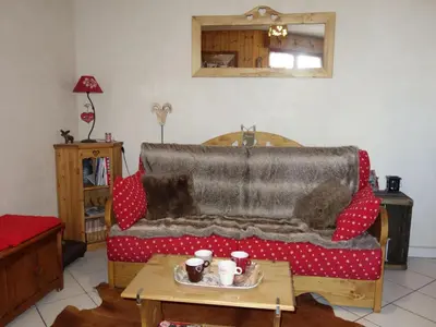 a living room with a couch and a table at Apartment Bel Alp 23 by Interhome in Saint-Gervais-les-Bains