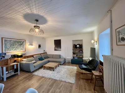 a living room with a couch and a table at Appartement pour 14 pers, rénové, animaux acceptés, parking - FR-1-624-92 in Samoëns